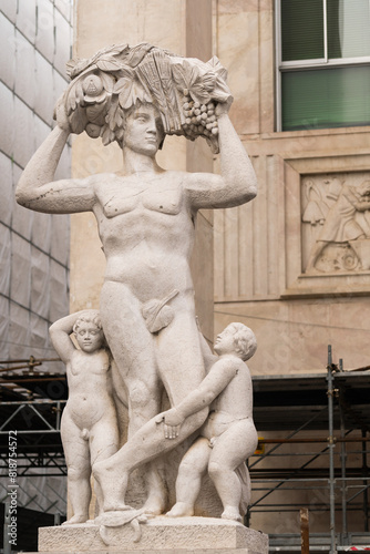 statue of man and children with fruit basket