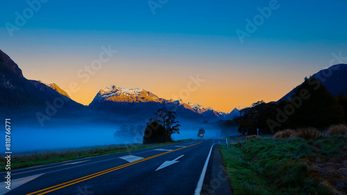 The Road trip view of  travel with mountain view of autumn scene and  foggy in the morning with sunrise sky scene at fiordland national park photo