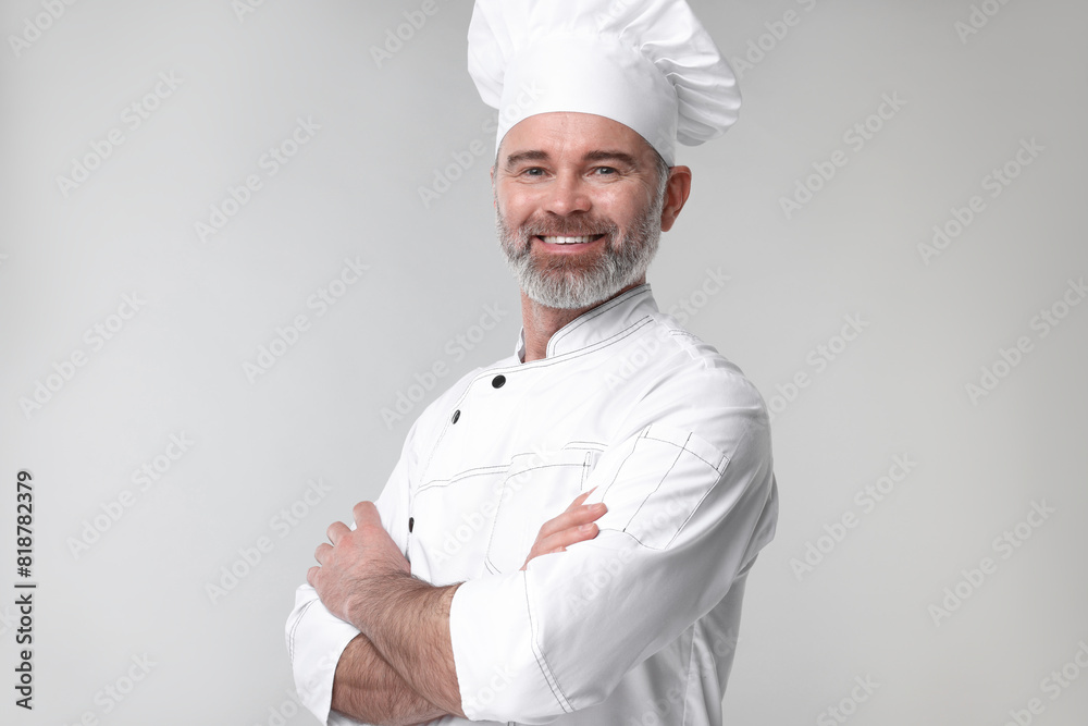Happy chef in uniform on grey background Happy chef in uniform on grey background
