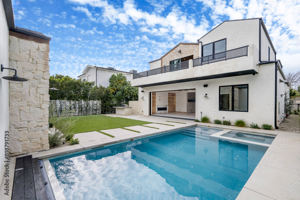 Fototapeta premium a white house with a swimming pool in the front yard