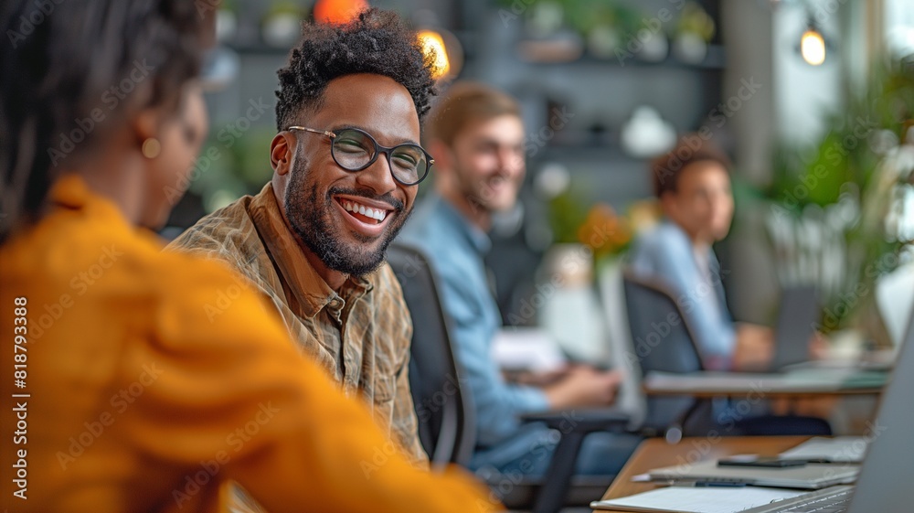 A disabled project manager laughingly converses with coworkers in the workplace A disabled project manager laughingly converses with coworkers in the workplace