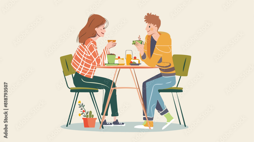 Funny young man and woman sitting at table and eating