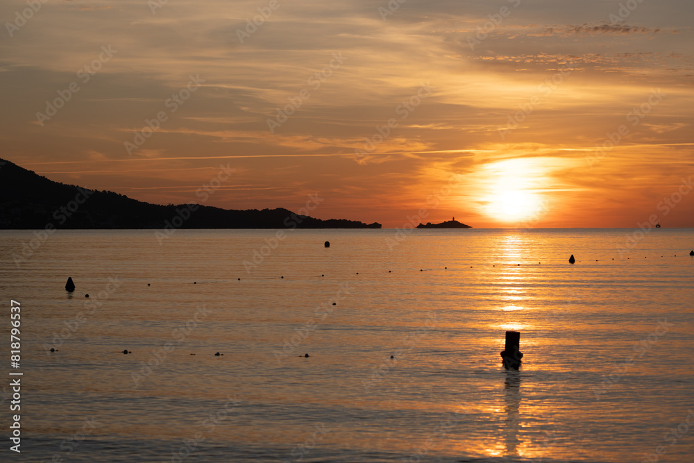 Sunset casting warm hues on rippling water, as seagulls soar in the sky Sunset casting warm hues on rippling water, as seagulls soar in the sky