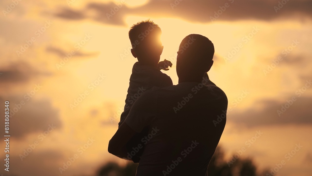 Father care is important kid toddler for a healthy family. happy family kid concept. The silhouette of the father holding the son was visible in the sunshine dream. father and son in a forest park