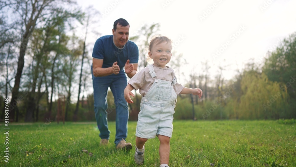 baby toddler and father run play in the park. happy family kid dream concept. baby and father together run play the grass in the summer sunset in the park. father and baby run in lifestyle the park