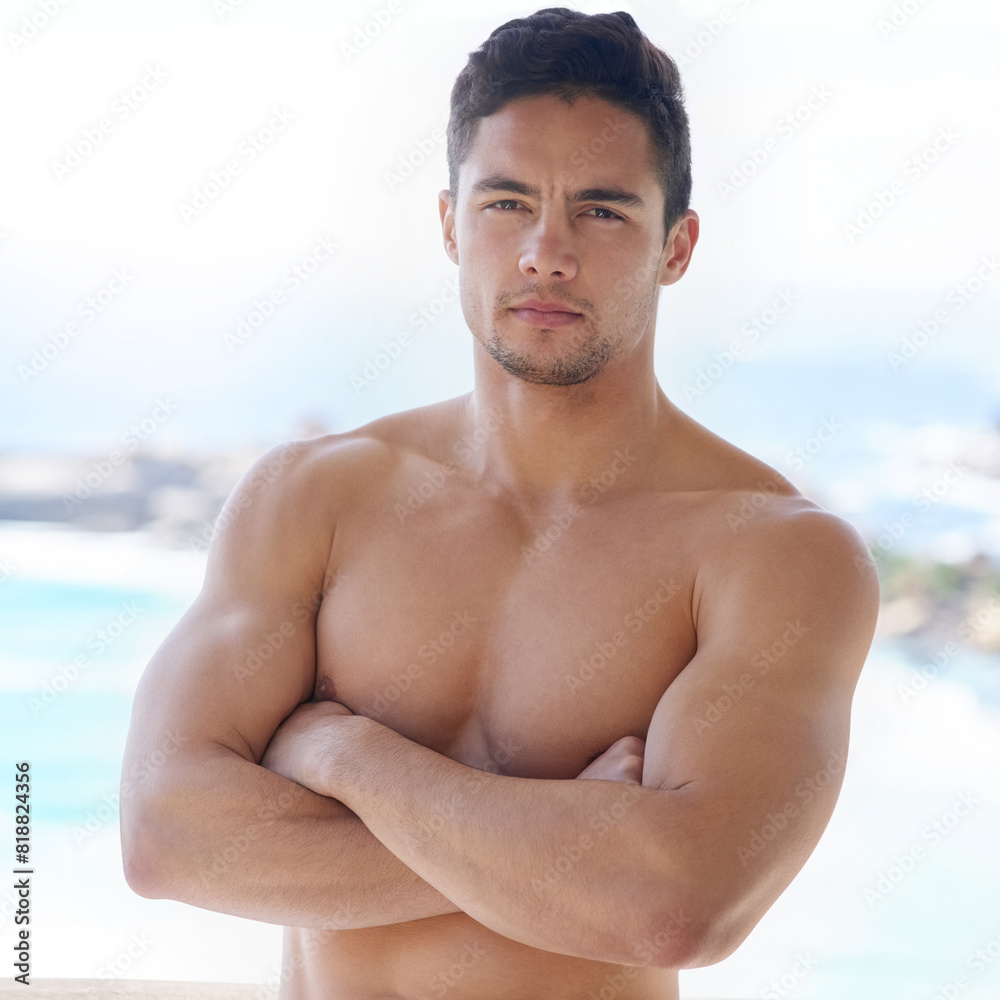 Portrait, beach or topless man with arms crossed, power and strength in workout, training or exercise. Holiday, outdoor and confident athlete with muscle for sports challenge, fitness or wellness