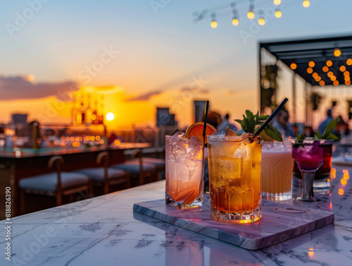 Variety of colorful cocktails on a rooftop bar with a stunning sunset view, creating a perfect setting for relaxation and socializing. Refreshing Cocktails on Rooftop Bar at Sunset

