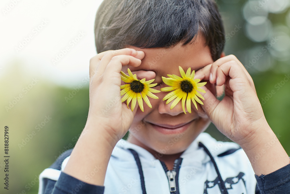 Boy, happy and flower eyes outdoor in nature for playing game, creativity and social development. Kid, smile and sunflower on face in summer at park for fantasy, storytelling and children adventure Boy, happy and flower eyes outdoor in nature for playing game, creativity and social development. Kid, smile and sunflower on face in summer at park for fantasy, storytelling and children adventure