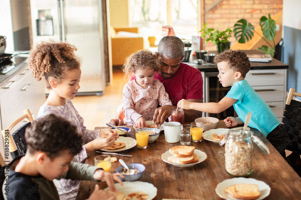 Father having breakfast with children at home Father having breakfast with children at home
