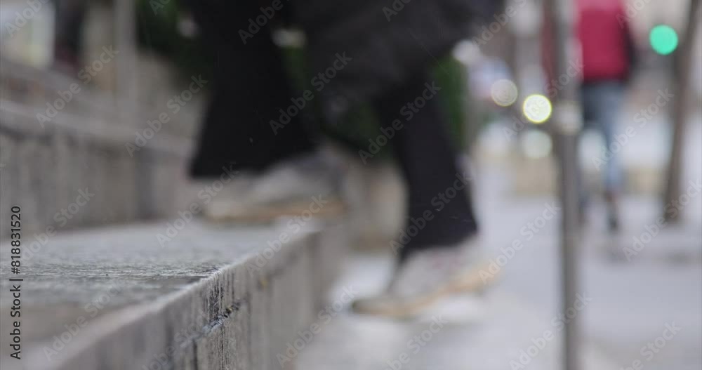 Closeup shot of rain pouring on the staircase with people walking in the blur background, Germany Closeup shot of rain pouring on the staircase with people walking in the blur background, Germany