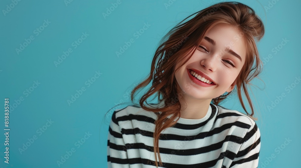 Beautiful girl in a striped sweater cute smiling.