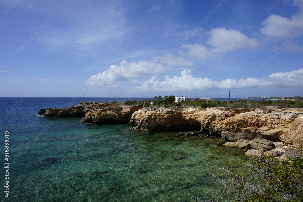Areal view of The Anguilla Arch merging with the azure waters Areal view of The Anguilla Arch merging with the azure waters