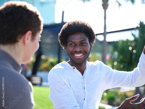 Man and woman having a conversation outside photo