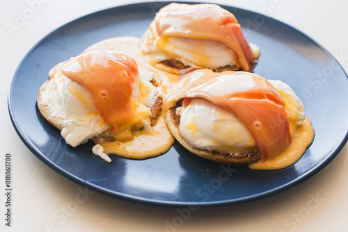 Breakfast with salmon and egg benedict on a toasted bun. Healthy breakfast in the morning on the table