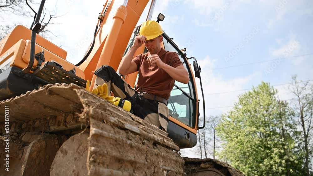 Construction Worker Excavator Operator in Hard Hat Working at Site Construction Worker Excavator Operator in Hard Hat Working at Site