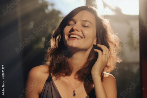 portrait of a beautiful woman with her hand on her neck laughing