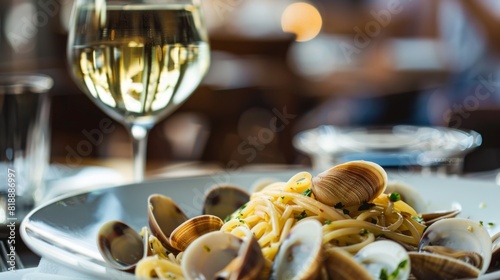 Spaghetti alle vongole served in a stylish restaurant setting with a glass of white wine
