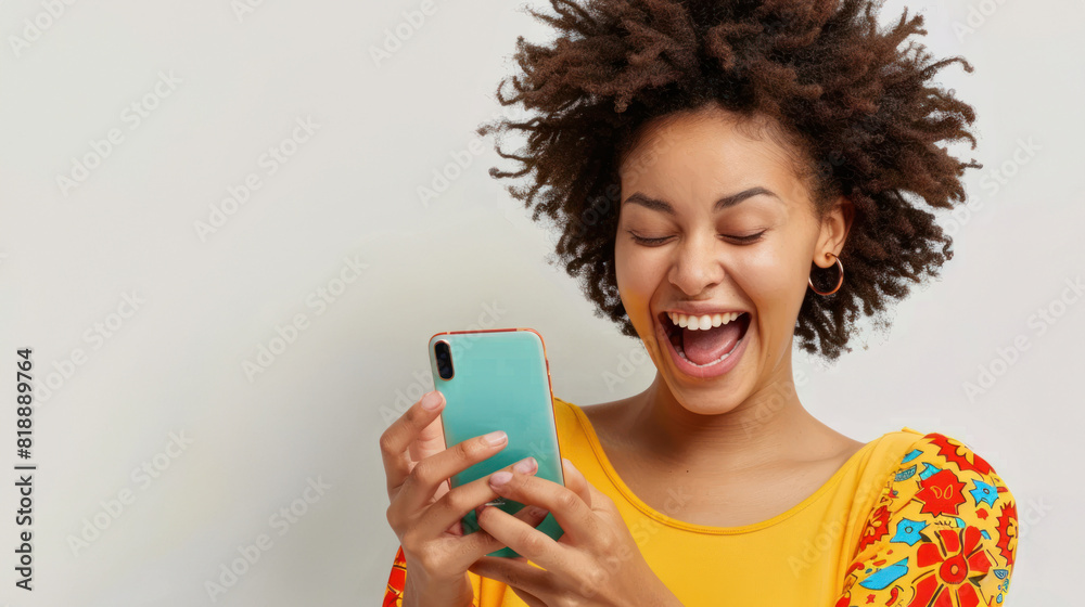 Excited Woman Using Smartphone - Joyful woman with curly hair looking at her smartphone, celebrating a happy moment, dressed in a bright yellow top. Excited Woman Using Smartphone - Joyful woman with curly hair looking at her smartphone, celebrating a happy moment, dressed in a bright yellow top.