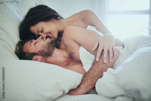 Love  morning and couple in bed with kiss  romance and happy bonding in apartment. Relationship  man and woman relax in bedroom with intimate embrace  passion and wake up with care on weekend in home