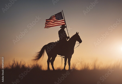 silhouette of a cowboy with an American flag on his horse, sunset
