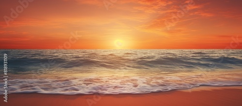 A beautiful beach with the setting sun reflecting on the calm glistening sea Copy space image photo