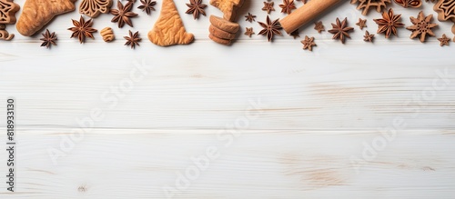 A composition featuring a copy space image with cookie cutters a whisker and a rolling pin on a white textured wooden surface as seen from above photo