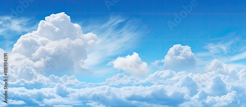 The sky boasts a breathtaking display of vivid blue and fluffy clouds providing an ideal setting for a copy space image