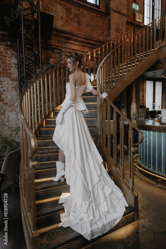 A young couple in wedding looks posing in a stylish loft bar.