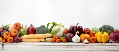 A copy space image of healthy autumn vegetables placed on a white wooden background © StockKing