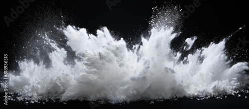 A dynamic and vibrant image of white powder bursting against a sleek black backdrop creating an explosive and captivating copy space image