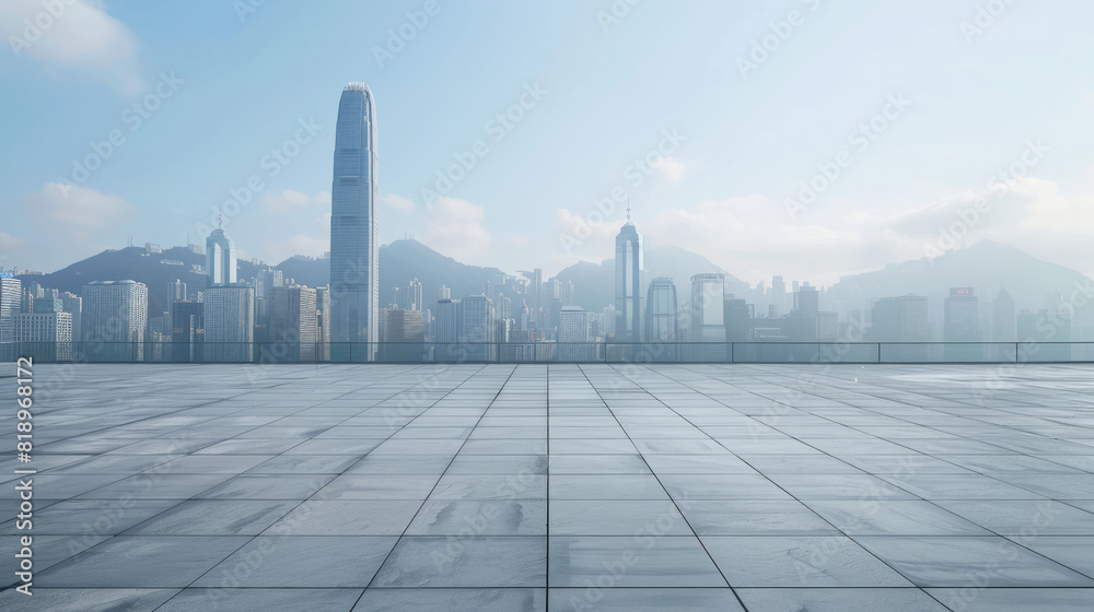 wide, empty urban space opens up to a panoramic view of a distant city skyline shrouded in mist. The expanse of smooth, reflective pavement contrasts with the towering skyscrapers under a cloudy sky