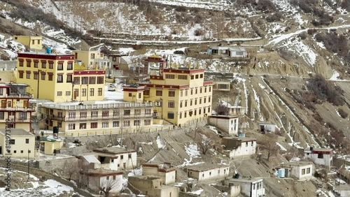 Houses of Dhankar Village nestled amidst Snow covered Mountains in winter. photo