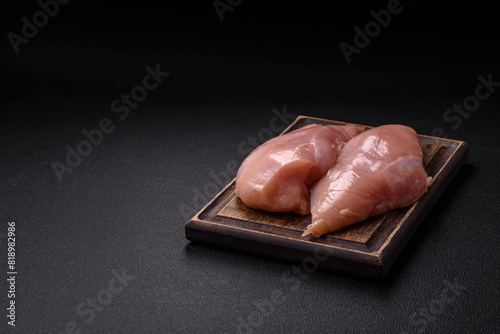 Raw chicken fillet with salt, spices and herbs