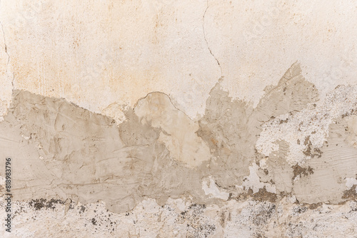 A wall in poor condition with patches of cement over the paint