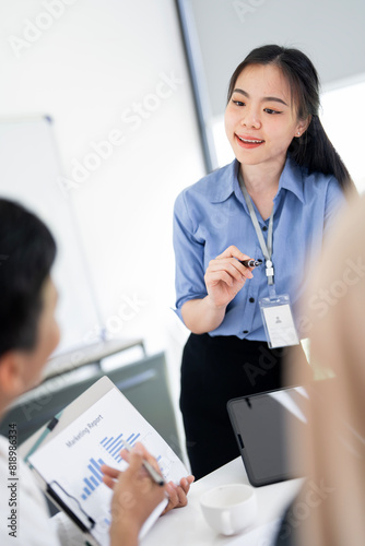 Smiling businesswoman actively participating in a team discussion during a meeting © NAMPIX
