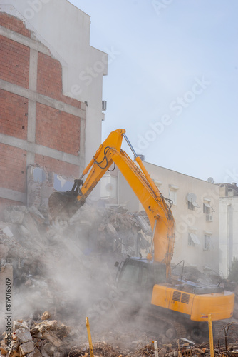 Building demolition excavator with long mechanical arm. Destruction of a house. Heavy machinery, hydraulic construction equipment.