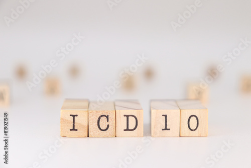 icd 10 acronym. Concept of International Classification of Diseases written on wooden cubes isolated on white backround photo
