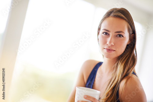 House, portrait and girl with coffee in kitchen, relax and breakfast in morning, calm and peace in weekend. Home, chill and woman with tea in cup to drink, beverage and break in apartment to enjoy