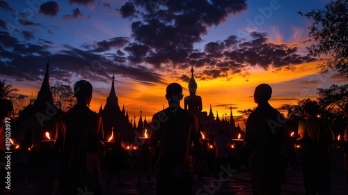 temple's silhouette against the evening sky, with worshippers carrying candles on Magha Bucha Day