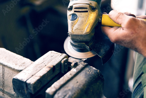 Skilled worker grinding metal