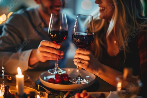 Couple toasting wine glasses during dinner date