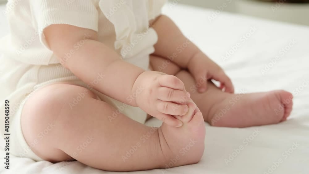 the legs of a small child on a white background on the bed, a pl the legs of a small child on a white background on the bed, a pl