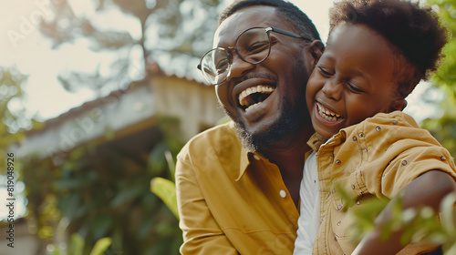 Happy father and child laughing together, an endearing Father's Day concept.