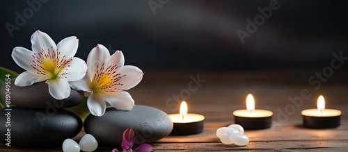 Spa still life with stones flower and candlelight on wooden background. copy space available
