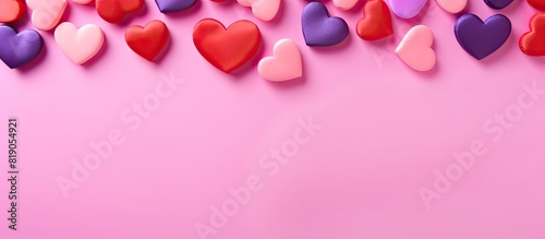 Heart of different colors on a pink background Valentine s day concept. copy space available © Gular
