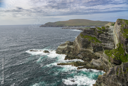 Large Body of Water Next to Rocky Cliff