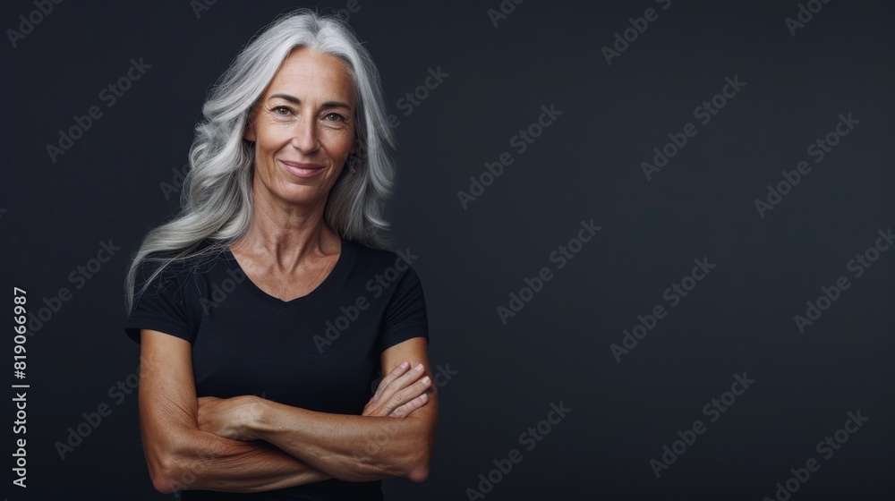 Mid age woman standing behind a flat background Mid age woman standing behind a flat background