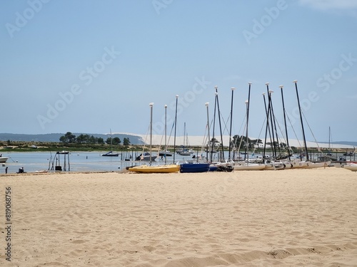 White sand beach at Cap Ferret, France with view of boats and Dune du Pyla during summer