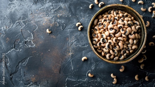 Close-up of bowl filled with black-eyed peas against dark textured background