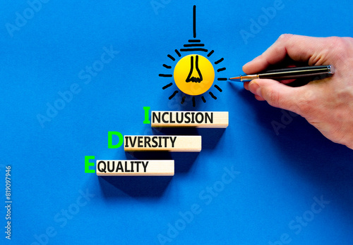 EDI equality diversity inclusion symbol. Concept words EDI equality diversity inclusion on blocks. Beautiful blue background. Business EDI equality diversity inclusion concept. Copy space.
